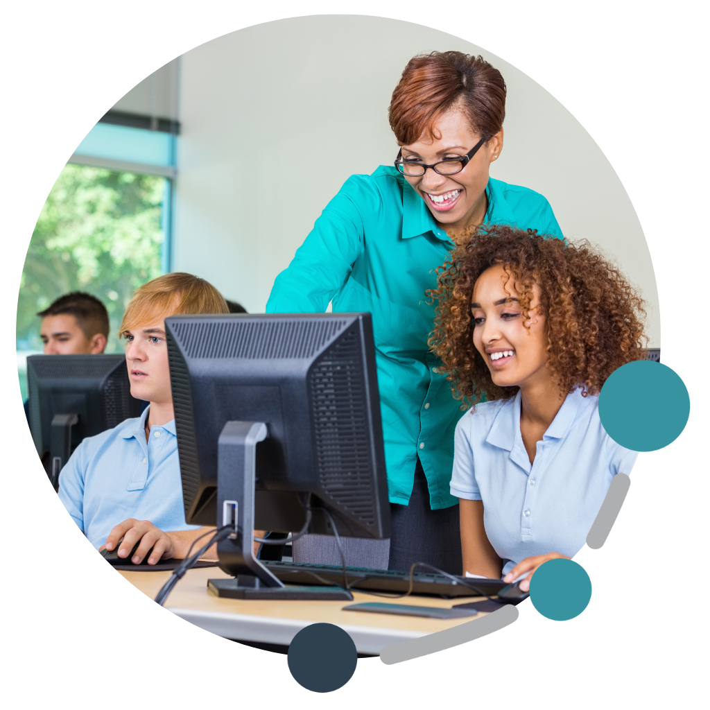 Teacher helping student at the computer